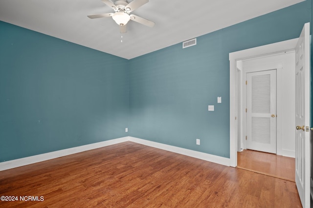 spare room featuring wood-type flooring and ceiling fan