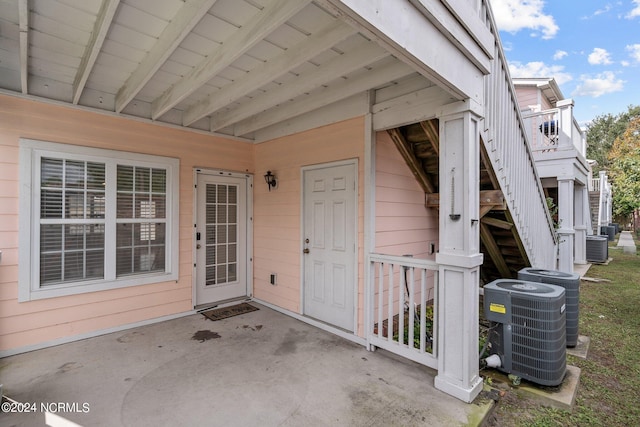 entrance to property with cooling unit and a patio area