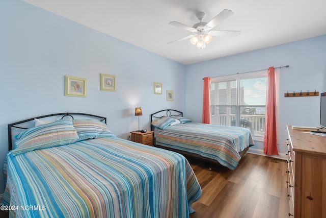 bedroom featuring ceiling fan and dark wood-type flooring