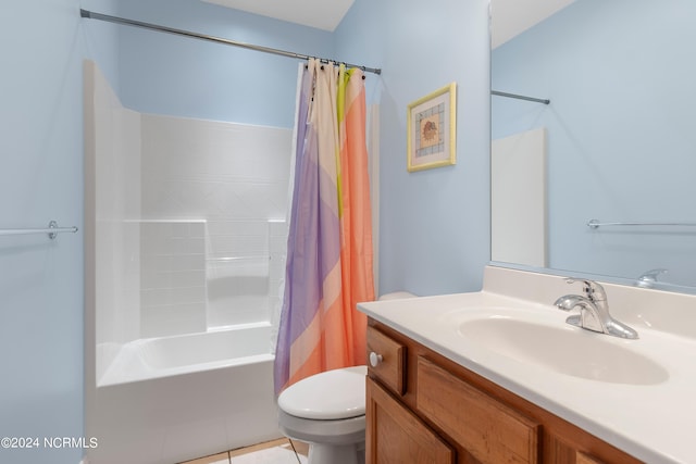 full bathroom with shower / tub combo with curtain, tile patterned floors, vanity, and toilet