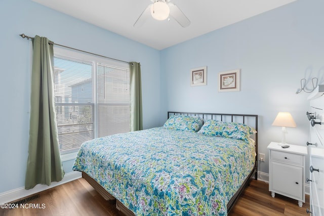 bedroom with ceiling fan, visible vents, baseboards, and dark wood-style flooring