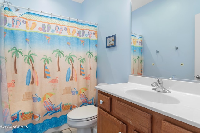 bathroom with vanity, tile patterned flooring, toilet, and curtained shower