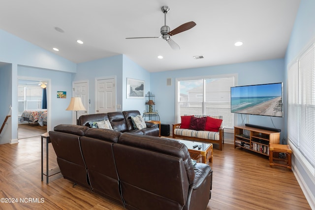 living room with plenty of natural light, a ceiling fan, wood finished floors, and vaulted ceiling