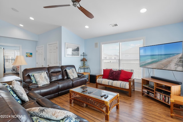 living room featuring ceiling fan, hardwood / wood-style floors, and vaulted ceiling