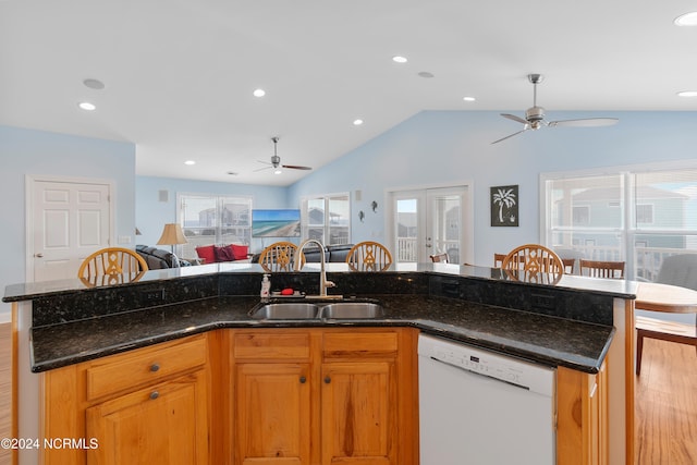 kitchen featuring open floor plan, white dishwasher, a sink, and ceiling fan