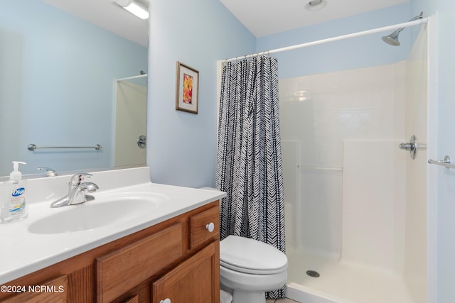 full bath with a shower with shower curtain, toilet, and vanity