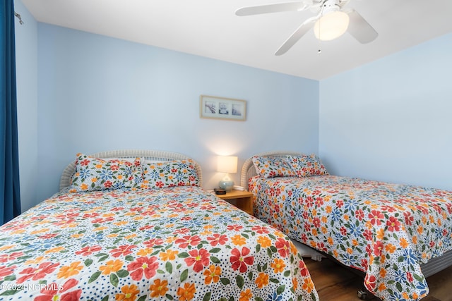 bedroom featuring wood finished floors and ceiling fan