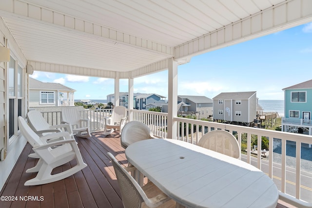 wooden deck with outdoor dining area and a residential view