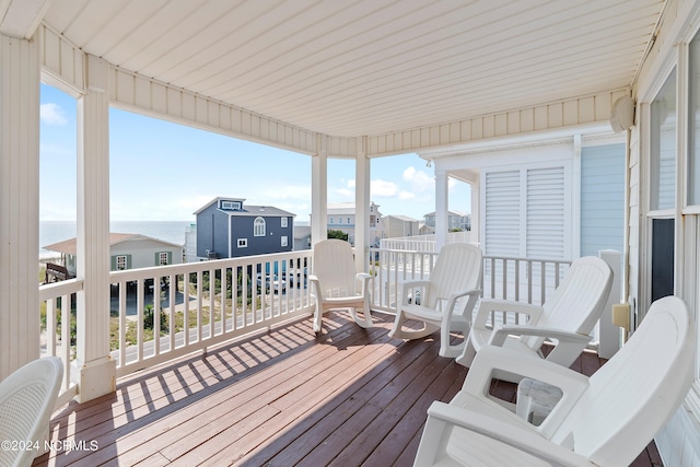 wooden deck featuring a water view