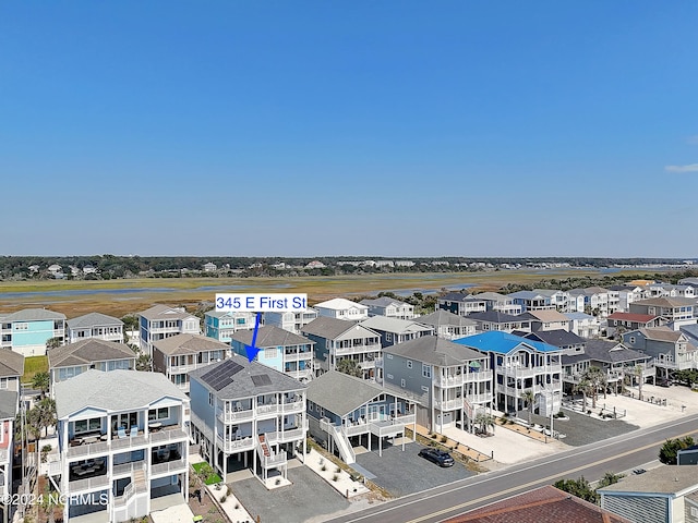 birds eye view of property with a residential view and a water view
