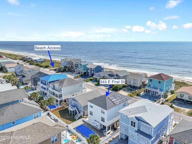 birds eye view of property with a beach view, a residential view, and a water view