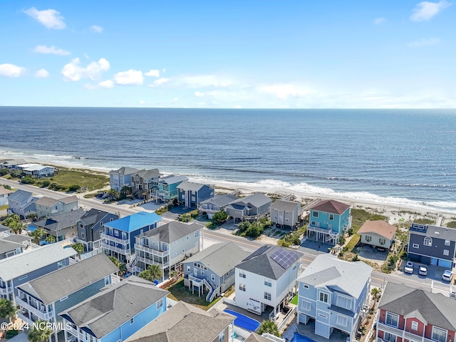 drone / aerial view featuring a beach view, a residential view, and a water view