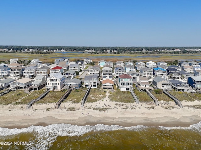 birds eye view of property featuring a view of the beach and a water view