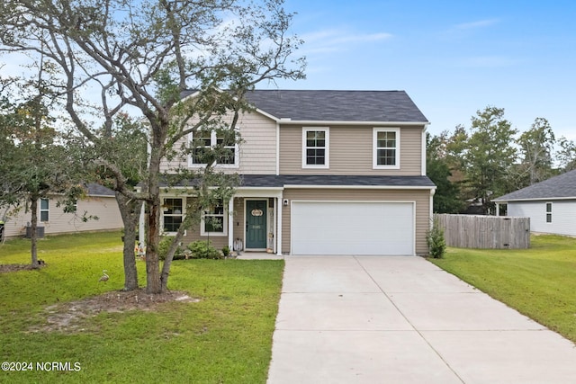 view of front of property with a garage and a front yard