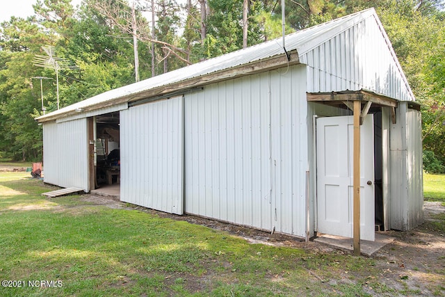 view of outbuilding with a lawn