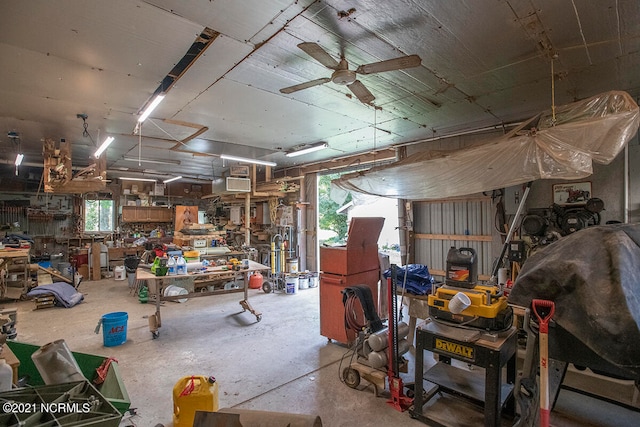 misc room with a workshop area, ceiling fan, concrete flooring, and a wealth of natural light