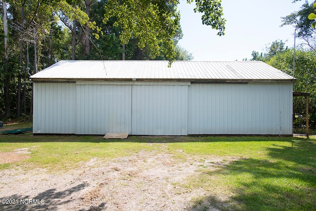 view of outbuilding with a lawn