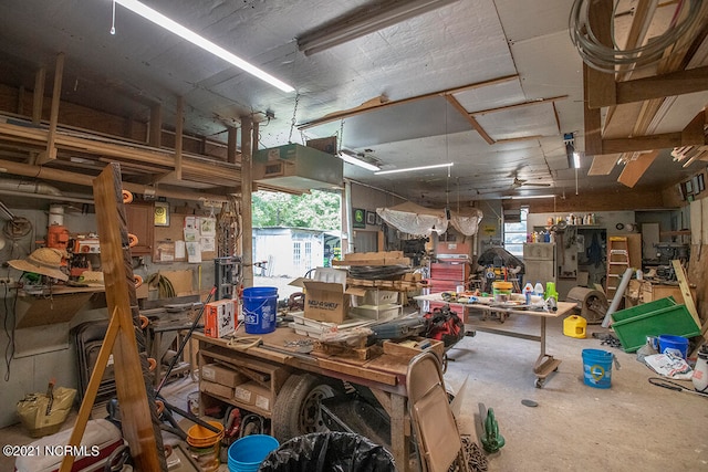 misc room with concrete flooring and a workshop area