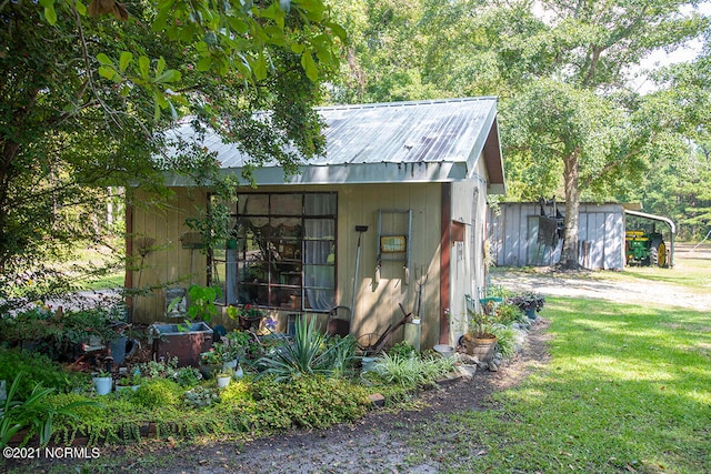 view of outbuilding with a lawn