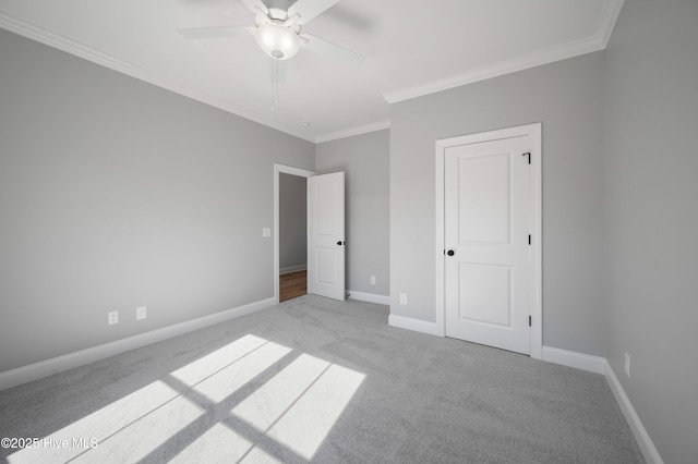 unfurnished bedroom featuring crown molding, light carpet, and ceiling fan