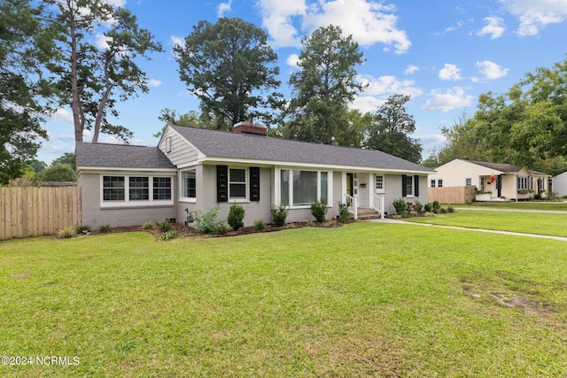 ranch-style house with a front lawn