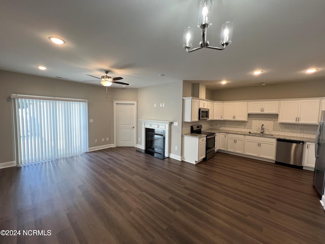 kitchen with white cabinets, sink, appliances with stainless steel finishes, ceiling fan with notable chandelier, and dark hardwood / wood-style flooring