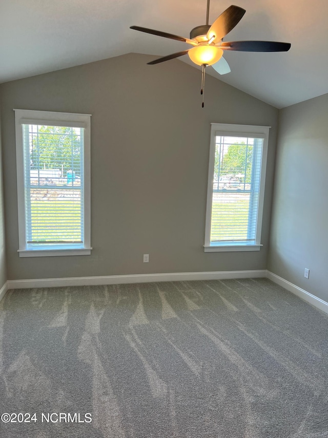 carpeted spare room with vaulted ceiling and ceiling fan