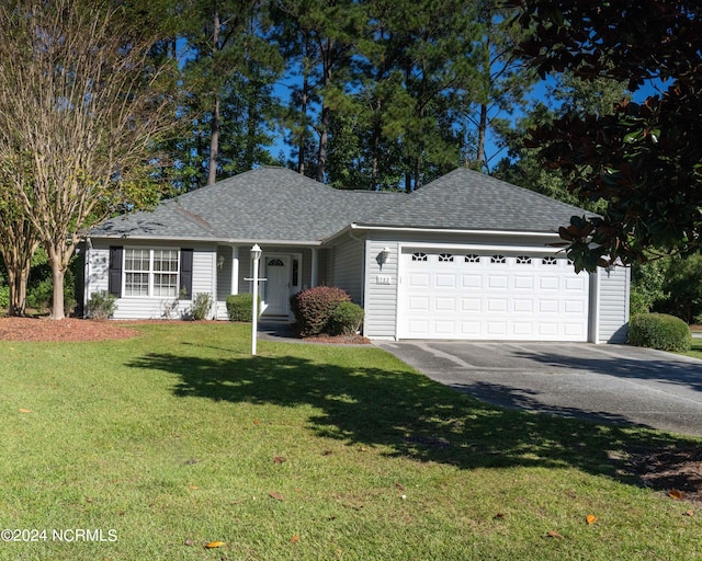 ranch-style house featuring a front yard and a garage