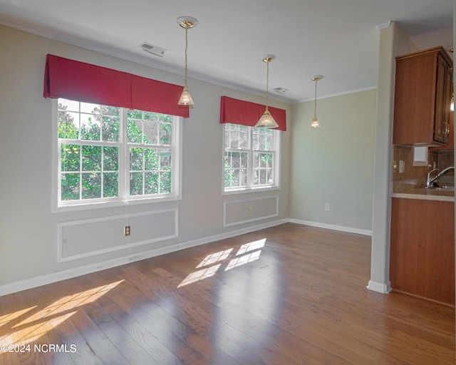 interior space with plenty of natural light, hardwood / wood-style floors, and tasteful backsplash