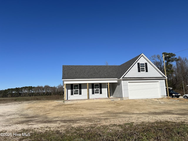 view of front of property with covered porch and a garage