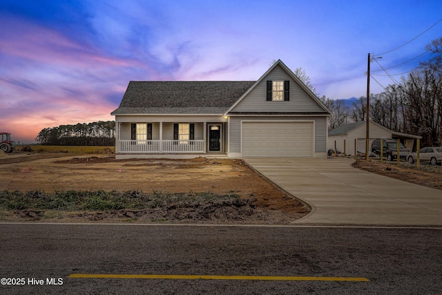 view of front facade featuring a porch, concrete driveway, and a shingled roof