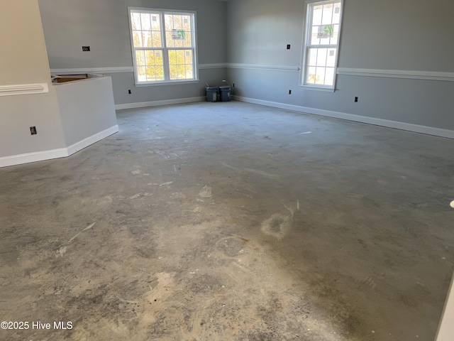 spare room featuring a wealth of natural light and concrete floors