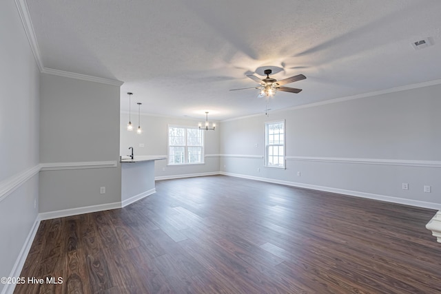 unfurnished room featuring visible vents, crown molding, ceiling fan with notable chandelier, dark wood-style floors, and a textured ceiling