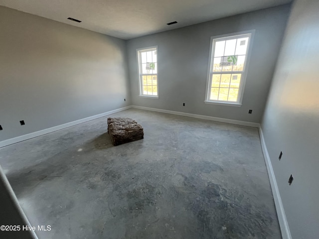 unfurnished room featuring concrete floors