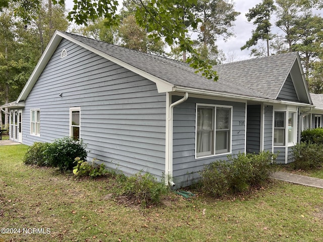 view of home's exterior with a yard