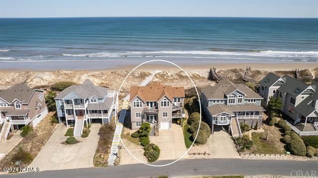 aerial view featuring a water view and a beach view