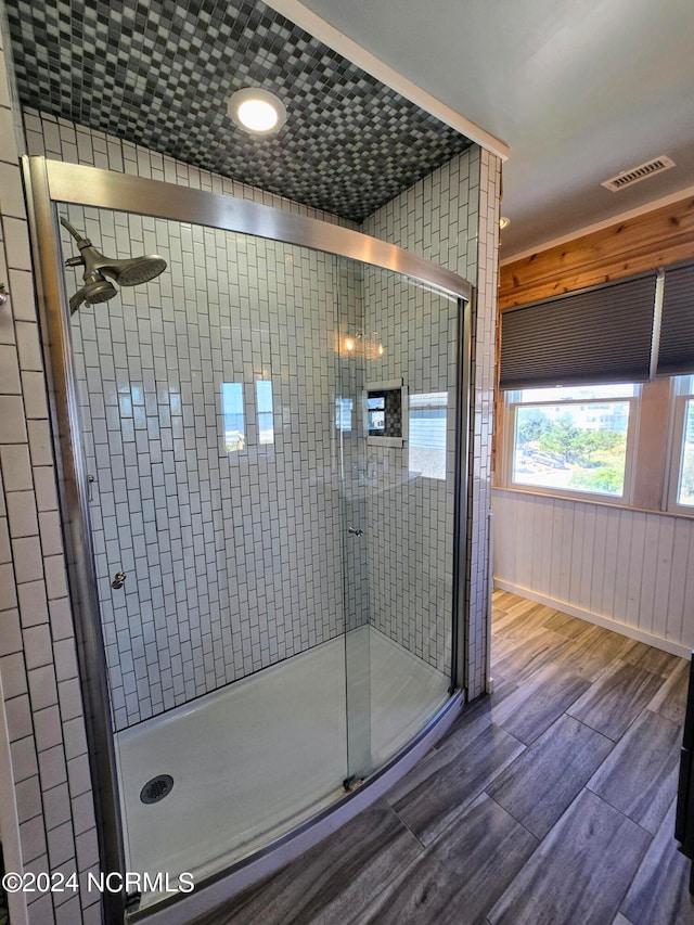 bathroom featuring a shower with shower door