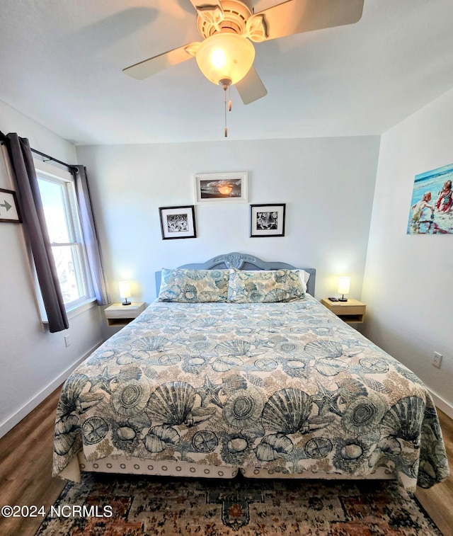 bedroom featuring ceiling fan and dark wood-type flooring