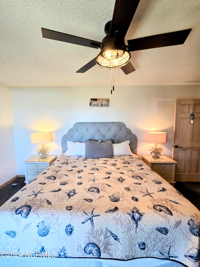 bedroom with ceiling fan and a textured ceiling