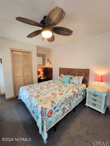 carpeted bedroom with ceiling fan and a closet