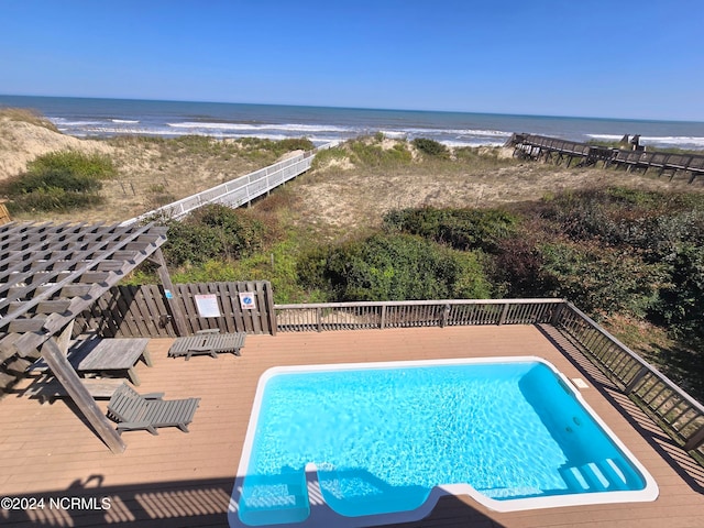 view of swimming pool with a view of the beach and a water view