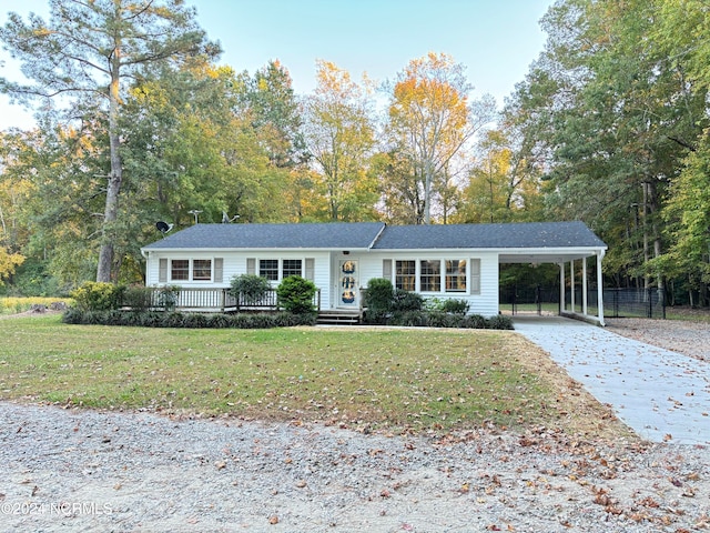 ranch-style home with a front lawn and a carport