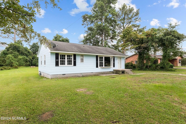 back of house featuring a yard