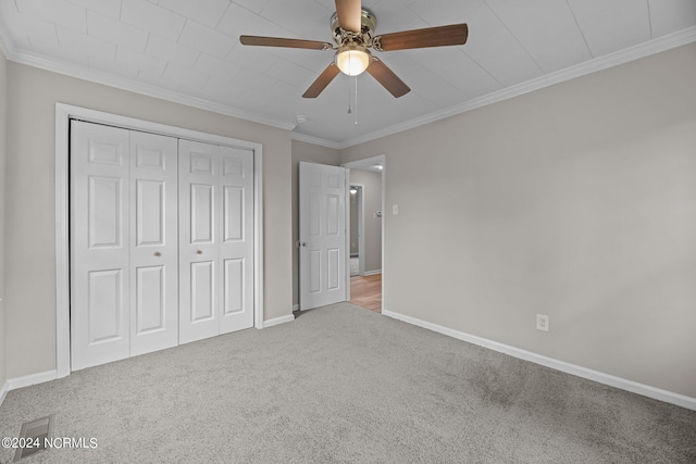 unfurnished bedroom featuring crown molding, light carpet, a closet, and ceiling fan