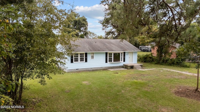 rear view of house featuring a lawn