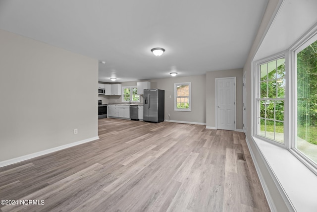 unfurnished living room with light hardwood / wood-style flooring