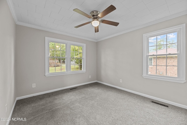 carpeted empty room with ceiling fan, a healthy amount of sunlight, and ornamental molding