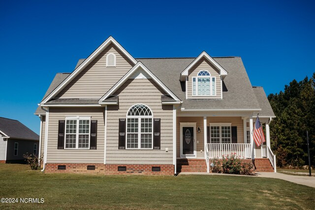 view of front of property with a porch and a front lawn