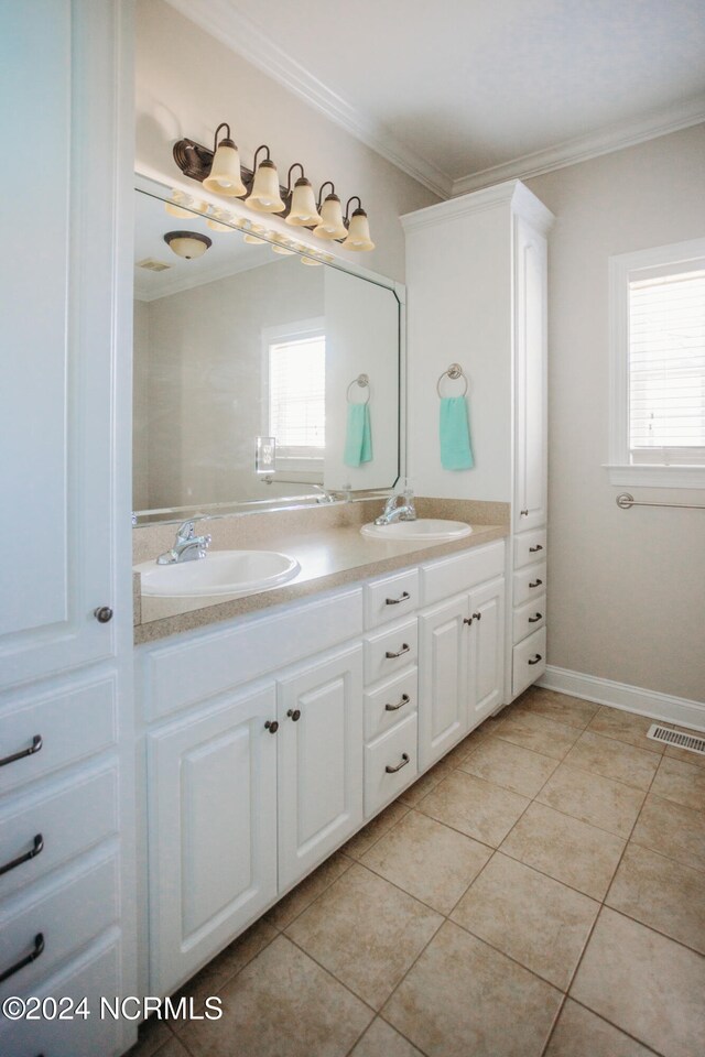 bathroom with crown molding, tile patterned floors, and vanity