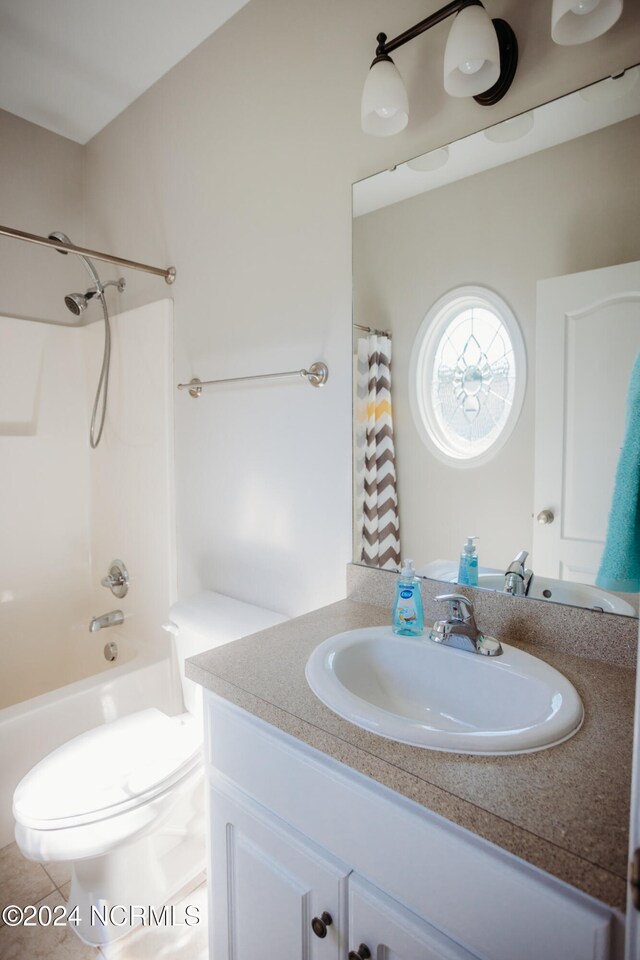 full bathroom with tile patterned flooring, shower / bath combo, vanity, and toilet